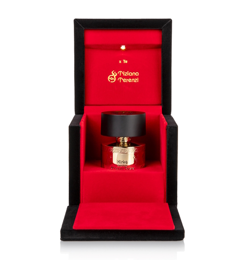 Zdjęcie przedstawia luksusowy flakon perfum **Tiziana Terenzi Kirke Overdose** umieszczony w eleganckim, aksamitnym etui. Opakowanie ma czarne zewnętrzne ścianki i intensywnie czerwone wnętrze, wyściełane miękkim materiałem. W centralnej części znajduje się złoty flakon z czarnym korkiem, ozdobiony nazwą zapachu i wytłoczeniami. Wewnątrz wieczka widnieje złote logo marki Tiziana Terenzi oraz napis „x Te”. Całość przypomina ekskluzywną szkatułkę, podkreślającą prestiż i wyjątkowość zapachu.